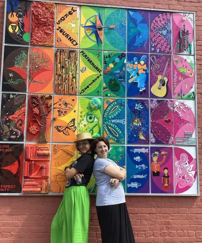 Marissa Hernandez of BluSeed Studios and Britt Sternberg of ADK ArtRise were among the artists who coordinated Saranac Lake’s “Welcoming and Belonging” mural which was unveiled on June 30, 2024 as part of the Village’s Pride celebration. Photo courtesy of BluSeed Studios. 